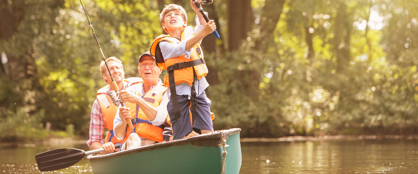 Three generations in a canoe fishing together.